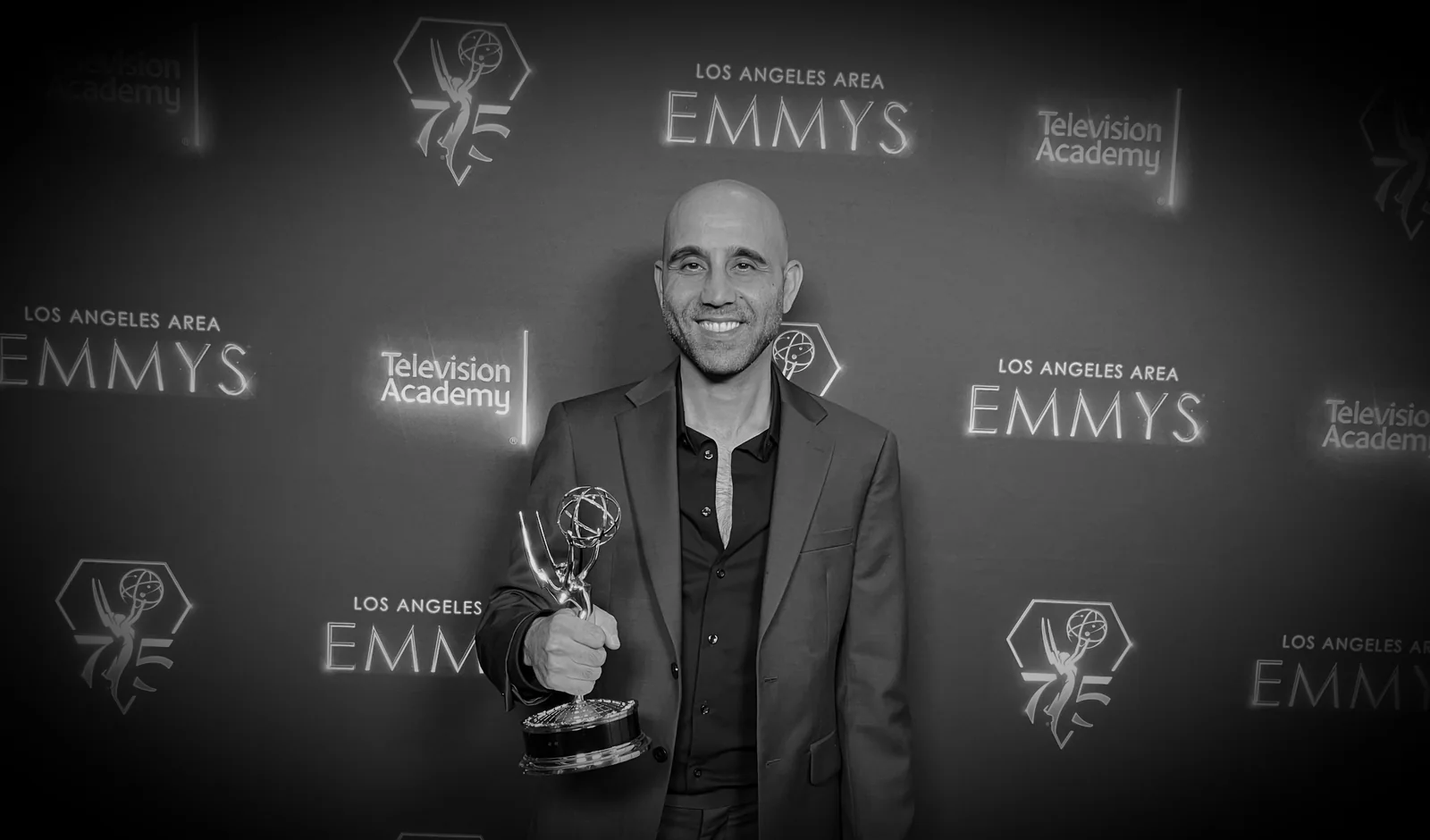 Edgar Sardarian, Emmy-winning editor and creative producer, holding his Los Angeles Area Emmy Award